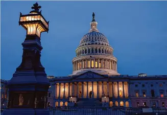  ?? J. Scott Applewhite/Associated Press ?? The U.S. Capitol in Washington is illuminate­d Friday evening as the Senate settled in for a rare weekend session to work on a package of wartime aid for Ukraine, Israel and other U.S. allies.