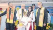  ?? HT PHOTO ?? (LR) Dr Ashok K Lahiri, former economic advisor, government of India, Dr Ram Naik, governor of UP, and Prof Khan Masood Ahmad, vice chancellor of the university, giving away the chancellor's medal to Nida Khan.