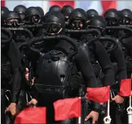  ??  ?? Combat divers take part in a military parade in Sevastopol to commemorat­e Russian Navy Day