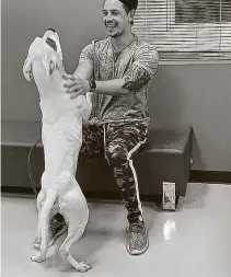  ?? Courtesy Converse Animal Care ?? California film producer Andre Lemmers reunites with his 1½-year-old pit bull, Milo, on May 20 at Converse Animal Care. Lemmers originally returned Milo to his breeder.