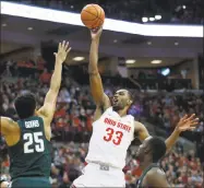  ?? Paul Vernon / Associated Press ?? Ohio State forward Keita Bates-Diop goes up to shoot between Michigan State forward Kenny Goins, left, and guard Joshua Langford during the second half Sunday.