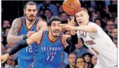  ??  ?? ON THE LOOSE: Kristaps Porzingis battles with Enes Kanter (left) for a loose ball with Steven Adams looking on. Carmelo Anthony (inset) reacts after being called for a foul.