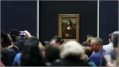  ?? AP PHOTO/THIBAULT CAMUS ?? In this Oct.23, 2019, file photo, tourists wait to see Leonardo da Vinci’s painting Mona Lisa, at the Louvre museum, in Paris.