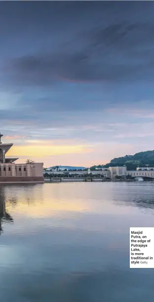  ?? Getty ?? Masjid Putra, on the edge of Putrajaya Lake, is more traditiona­l in style