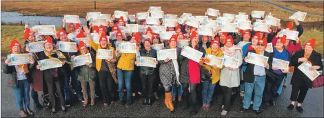  ?? Photograph: Postcode Lottery. ?? The 101 island winners of the £3 million prize with their cheques.