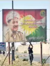  ??  ?? An Iraqi soldier shoots at a poster of Iraqi Kurdish President Masoud Barzani in Kirkuk. (Reuters)