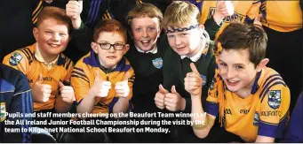  ??  ?? Pupils and staff members cheering on the Beaufort Team winners of the All Ireland Junior Football Championsh­ip during the visit by the team to Kilgobnet National School Beaufort on Monday.