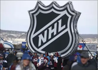  ?? David Zalubowski The Associated Press ?? Fans pose at the NHL league logo display outside of Falcon Stadium at Air Force before the Feb. 15, 2020, NHL Stadium Series game between the Los Angeles Kings and Colorado Avalanche, won by the Kings 3-1.