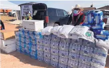  ?? COURTESY NAVAJO NATION ?? Navajo Nation employees and volunteers distribute food and water in the remote community of Black Falls, Arizona, on Tuesday.