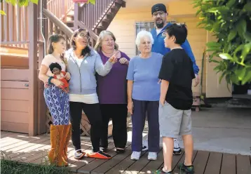  ?? Photos by Jessica Christian / The Chronicle ?? Four generation­s of family live in three homes next to one another in S.F., including Celina Gomes’ daughter Naima Sutton (left); Gomes; her mom, Mary Gomes; grandmothe­r Theresa Vella; brother Dominic Gomes; and son Walt Sutton.
