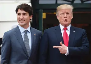  ?? THE CANADIAN PRESS/SEAN KILPATRICK ?? U.S. President Donald Trump points to Prime Minister Justin Trudeau Wednesday as he welcomes him to the White House in Washington, D.C.