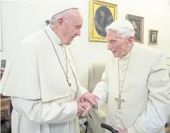  ?? AFP ?? Pope Francis, left, meets Benedict XVI at the Vatican.