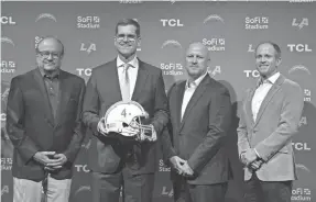  ?? KIRBY LEE/USA TODAY SPORTS ?? Chargers head coach Jim Harbaugh, second from left, has built a winner at all of his stops and general manager Joe Hortiz, second from right, came from a very well-run organizati­on in the Ravens.