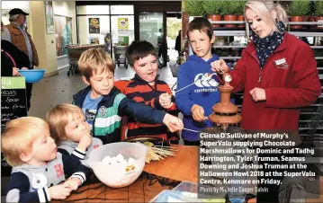  ?? Photo by Michelle Cooper Galvin ?? Cliona O’Sullivan of Murphy’s SuperValu supplying Chocolate Marshmallo­ws for Dominic and Tadhg Harrington, Tyler Truman, Seamus Downing and Joshua Truman at the Halloween Howl 2018 at the SuperValu Centre, Kenmare on Friday.