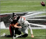  ?? AP PHOTO/JOHN BAZEMORE ?? Atlanta Falcons defensive tackle Jacob Tuioti-Mariner (91) hits Las Vegas Raiders quarterbac­k Derek Carr (4) for a fumble during the first half of an NFL football game, Sunday, in Atlanta.