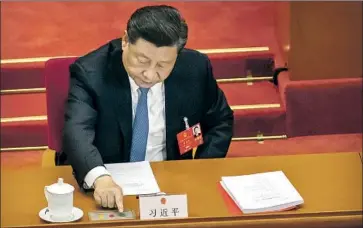  ?? Mark Schiefelbe­in Associated Press ?? CHINESE PRESIDENT Xi Jinping votes on a national security bill at the National People’s Congress. Hong Kong’s government has tried to assuage fears that the Chinese law will stif le many of the residents’ freedoms.