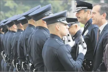  ?? Brian van der Brug
Los Angeles Times ?? MAYOR ERIC GARCETTI and LAPD Chief Charlie Beck inspect a recruit class in February. This week, protesters have demanded that Beck be fired over the August shooting death by police of Ezell Ford.