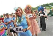  ??  ?? Competitor­s smile during the Fashionabl­y Saratoga category of the 27th annual Hat Contest on Sunday at Saratoga Race Course.