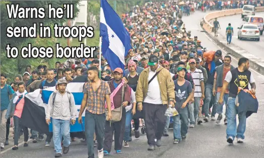  ??  ?? CONVOY-LUTED: Honduran migrants trek in Guatemala Wednesday en route to the Mexico-US border — and a showdown with President Trump.