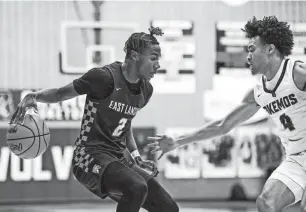  ?? ?? East Lansing’s Kelvin Torbert Jr., left, moves the ball as Okemos’ Josiah Thomas defends during the second quarter on Jan. 25 at Okemos High School.