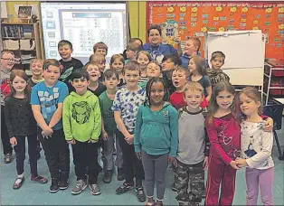  ?? Submitted photo ?? Mountain climber T. A. Loeffler poses for a photo with Ms. Pinsent’s Grade Two Class at St. Mary’s Elementary students during a recrnt visit.