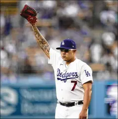  ?? ASHLEY LANDIS / ASSOCIATED PRESS ?? Los Angeles Dodgers pitcher Julio Urias raises his glove as he walks off the mound after the top of the first inning against the Milwaukee Brewers on Saturday in Los Angeles. Urias was the only 20-game winner in Major League Baseball this season.