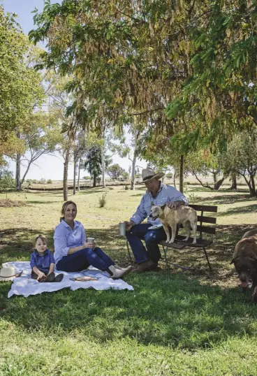  ??  ?? ABOVE, FROM LEFT The Umbearra Station homestead was originally a small Sydney Williams hut. A grapevine grows along the front awning with grapes ready to pick each Christmas; Oliver, Kimberley, Tara, the 11-year-old labrador, Angus and Tinker, an Australian stumpy tail cattle dog, enjoying a picnic in the garden. FACING PAGE Tinker, Oliver and Angus heading to the shed.