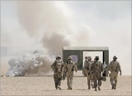  ?? OP IMPACT FILES ?? Royal Canadian Air Force members of Air Task Force-Iraq and several coalition members participat­e in a combat search and rescue exercise in Kuwait. After a vote in Parliament Monday night, the mission will be extended by another year and Canadian...