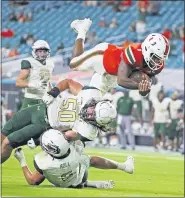  ?? AL DIAZ — MIAMI HERALD VIA AP, FILE ?? .
File-Miami quarterbac­k D’Eriq King (1) leaps for a secondquar­ter touchdown against UAB during an NCAA college football game in Miami Gardens, Fla., Thursday, Sept. 10, 2020. King will lead Miami against Florida State Saturday, Sept. 26, 2020.