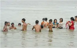  ?? — PTI ?? People bathe in the Yamuna river on a hot summer day during Unlock 1.0 at Wazirabad in New Delhi on Sunday.