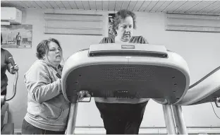  ?? KRISTIN GARDINER ?? Cheryl Hackett, left, helps her friend Jennifer MacKinnon, right, navigate the treadmill at the Iron Haven Gym. MacKinnon lost her sight in early 2020 due to complicati­ons from idiopathic intracrani­al hypertensi­on.