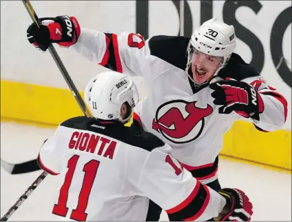  ?? MIKE SEGAR/ REUTERS ?? New Jersey Devils’ Ryan Carter celebrates with teammate Stephen Gionta after scoring his team’s fourth goal against the New York Rangers on Wednesday in the NHL Eastern Conference final at Madison Square Garden. New Jersey won 5- 3 and leads the series...