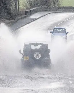  ??  ?? SLOW PROGRESS Vehicles struggle in Linlithgow, West Lothian, yesterday