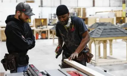  ?? JESSICA RINALDI/GLOBE STAFF ?? Brandel Johnson (right) worked with fellow apprentice Ryan Phelps on a cut inside Forge.