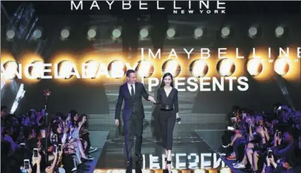  ?? PROVIDED TO CHINA DAILY ?? Stephane Rinderknec­h, CEO of L’Oreal China, and actress Angelababy show up at a party to launch Maybelline’s new global brand statement “Make it happen” in the Chinese