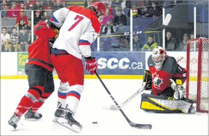  ?? SALTWIRE NETWORK PHOTO/TRURO DAILY NEWS ?? Canada West goalie Zach Rose, who is from Paradise, keeps his eyes on the puck, while Russia’s Vladislav Kotkov tries to get a shot off during the Canadian’s round-robin win over the Russians at the World Junior A Hockey Challenge in Truro, N.S., this...