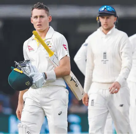  ?? Picture: AFP PHOTO ?? Australia's Marnus Labuschagn­e walks back as Joe Root looks on following the controvers­ial catch.