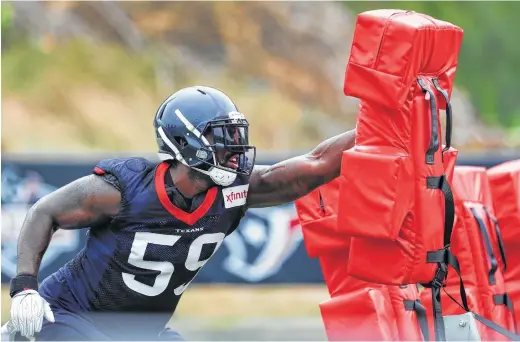  ?? Brett Coomer / Houston Chronicle ?? Texans outside linebacker Whitney Mercilus, hitting a blocking sled at camp Thursday, played a significan­t role on the NFL’s No. 1 defense last year.