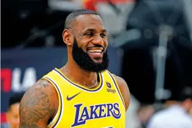  ?? RYAN SUN/THE ASSOCIATED PRESS ?? Los Angeles Lakers forward LeBron James smiles Monday during the team's media day in El Segundo, Calif. The NBA's preseason schedule begins Thursday.