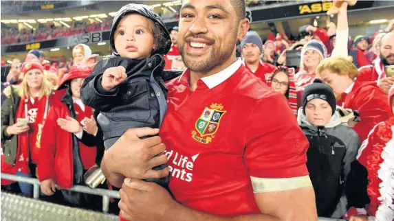  ??  ?? British and Irish Lions number eight Taulupe Faletau celebrates with son Israel and, below left, rugby fan Richard Lawrence in New Zealand