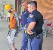  ??  ?? Cops taking away a handcuffed Harpreet Singh Khalsa. A witness captured the arrest on video and posted it to her Facebook page. Khalsa was later released without charges.
