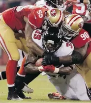  ?? TONY AVELAR/The Associated Press ?? Atlanta Falcons running back Steven Jackson is tackled by 49ers’ Ahmad Brooks and Glenn Dorsey Monday night in
the last game at Candlestic­k Park in San Francisco.
