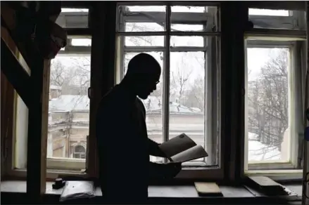  ?? KOLESNIKOV­A/AFP NATALIA ?? Historian Mikhail Melnichenk­o, 33, displays pages from a Soviet-era diary during an interview in Moscow on February 27.