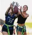  ?? Ashley Landis/Associated Press ?? Aly Young, 17, left, and Shale Harris, 15, reach to catch a pass as they try out for the Redondo Union High School girls flag football team in Redondo Beach, Calif.