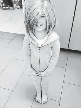  ?? HELEN PELTON ?? Helen Pelton’s granddaugh­ter Claire wearing her Grandma’s wig.