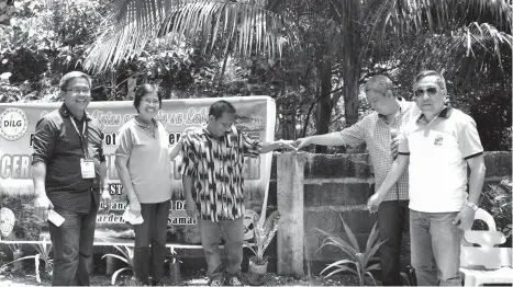  ??  ?? AUNDANAO BARANGAY Captain Romero Papacoy (center) tests the flow of water from the faucet turned over by the local government unit of the Island Garden City of Samal through the Salintubig–Provision of Potable Water Supply Project. He is joined by...