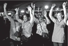  ??  ?? People celebrate Tuesday after divers completed rescuing 12 boys and their youth soccer coach trapped in cave in northern Thailand, ending a two-week ordeal. The last four boys and the coach were rescued Tuesday.