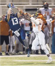  ?? GREG SORBER/ JOURNAL ?? La Cueva’s Grant Giesler (13) reaches in vain for a pass as Eldorado’s Jonah Ball defends during their Class 6A quarterfin­al at Community Stadium on Friday night.