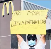  ?? FREDERIC J. BROWN/GETTY-AFP ?? A McDonald’s employee protests April 9 in Los Angeles. McDonald’s says it will start anti-harassment training worldwide in 2022.