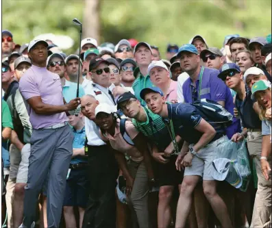  ?? (AP file photo) ?? Patrons at Augusta National Golf Club watch a shot by Tiger Woods during the 2019 Masters. The club announced Wednesday that spectators will be not be allowed to this year’s tournament because of the coronaviru­s pandemic. It has already been moved from April to November due to concerns over the pandemic.